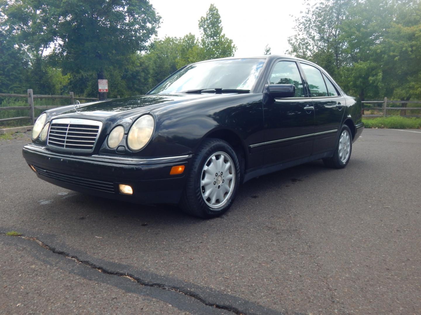 1999 Black /Tan Leather Mercedes-Benz E-Class E320 4-Matic (WDBJF82H2XX) with an 3.2L V6 SOHC 18V engine, 5-Speed Automatic Overdrive transmission, located at 6528 Lower York Road, New Hope, PA, 18938, (215) 862-9555, 40.358707, -74.977882 - Here we have a Mercedes E320 with a 3.2L V6 putting power to all four wheels via an automatic transmission. Options include: tan leather, wood trim, keyless entry, cruise control, tilt steering wheel, A/C, power windows/locks/mirrors, power moonroof, power and heated front seats, AM/FM/CD radio, dua - Photo#0